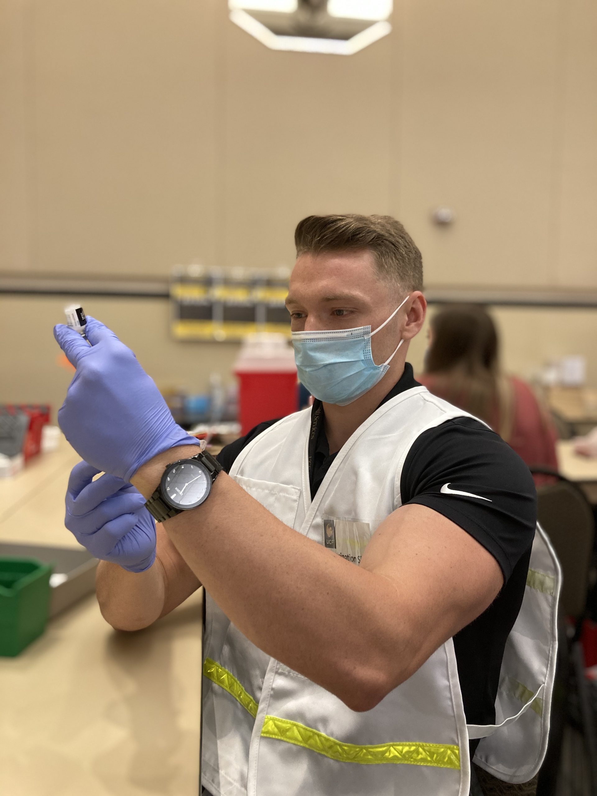 Shayne McKee at UCF drawing up the Pfizer COVID-19 vaccine during a volunteering event